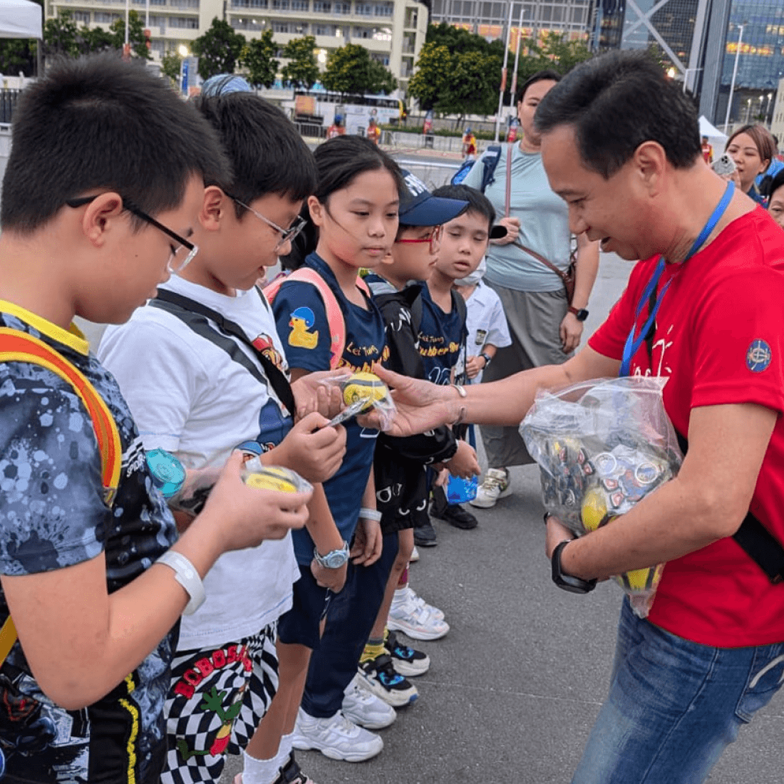 wbsc baseball volunteer distributing souvenirs to children