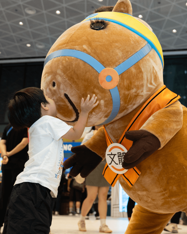 child-cuddling-with-captain-jc-mascot