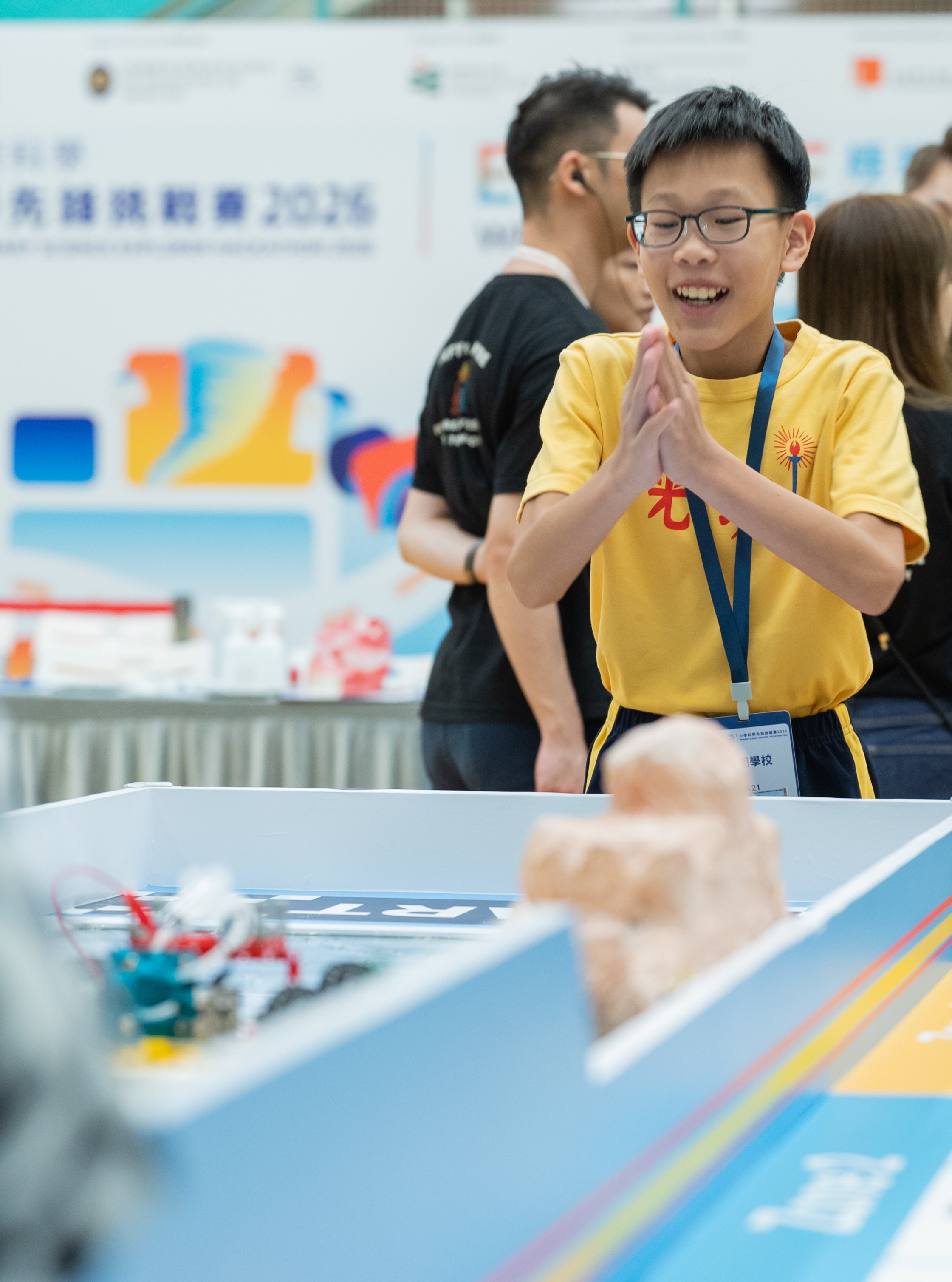 A finalist at the JC CoolScience Primary Science Explorer Hackathon 2026 reacts with excitement while engaging in a hands-on experiment for the "Extreme Weather Explorer" theme.