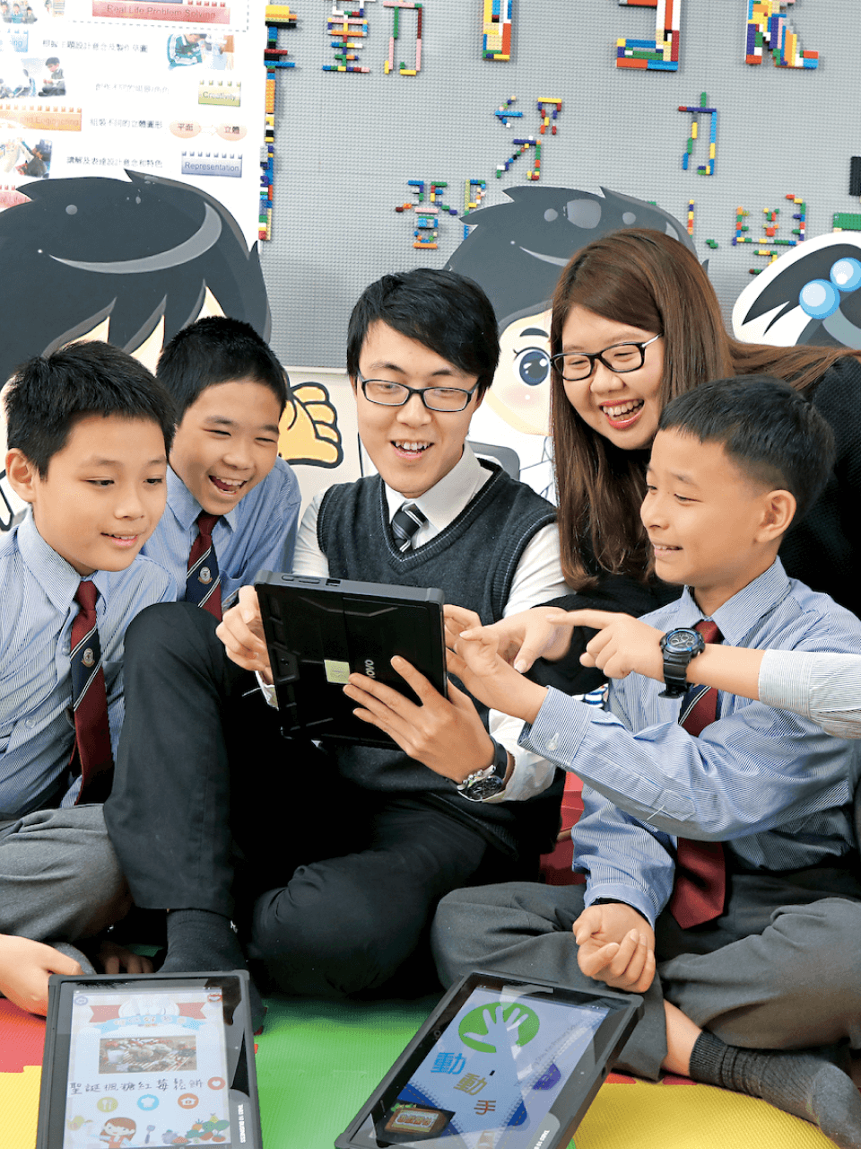 Students and teacher sitting on cushions discussing portrait image