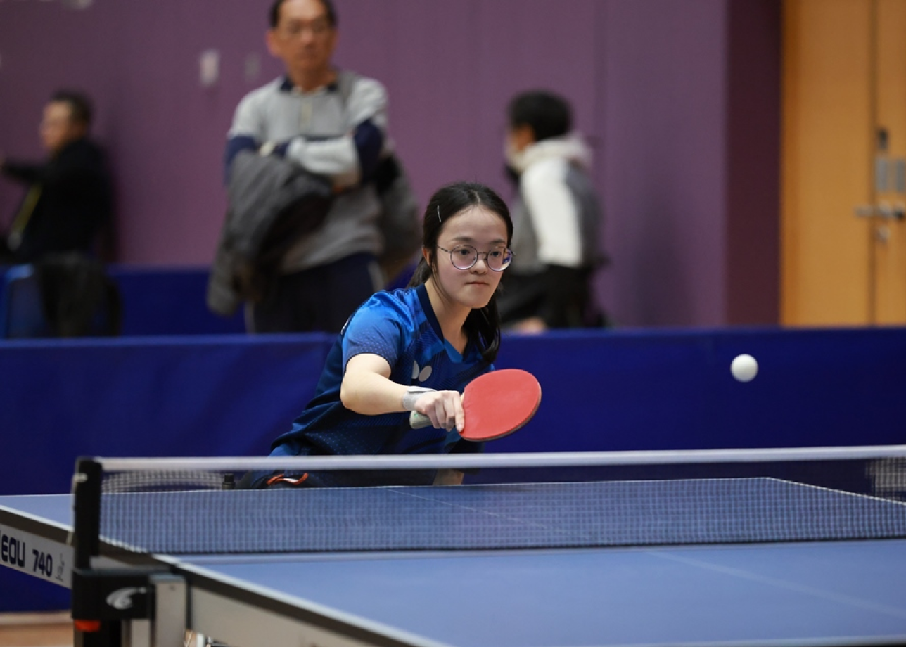 Athlete Yuen Wing-ki stays focused in a table tennis contest.