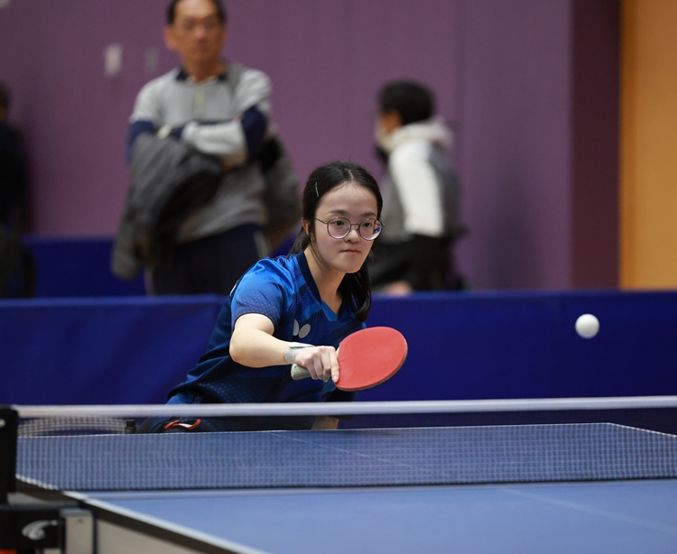 Athlete Yuen Wing-ki stays focused in a table tennis contest.